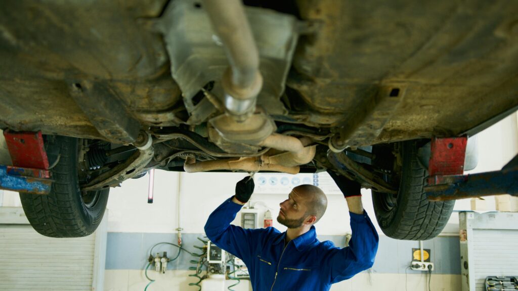 mechanic inspects car