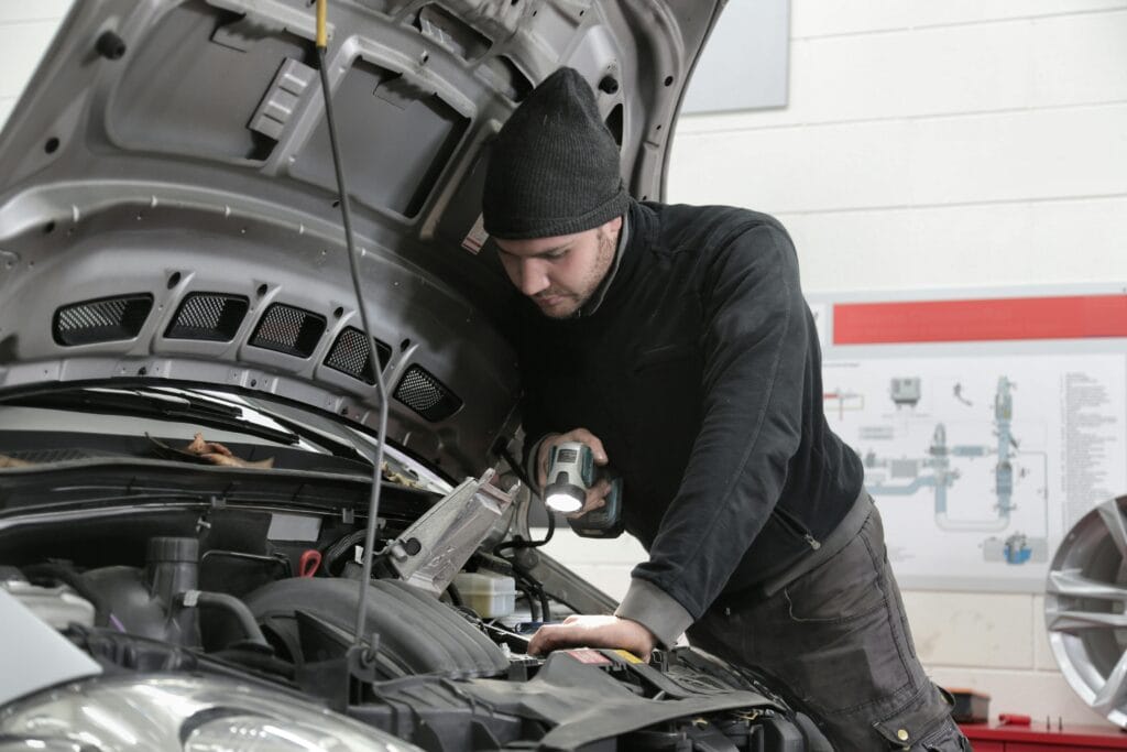 engine diagnostics man with flashlight